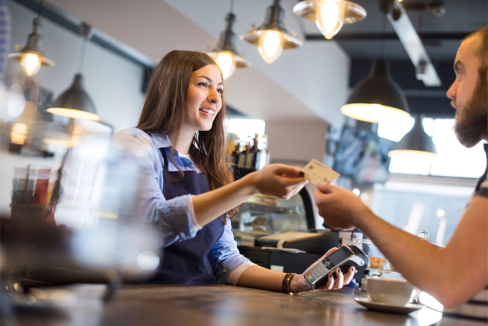 A customer making a credit card payment at a coffee shop