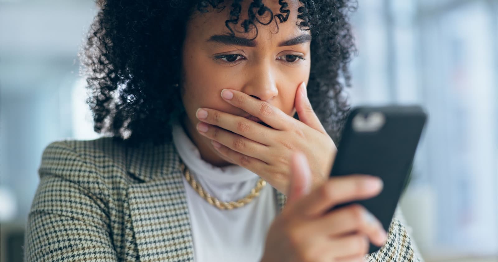 Worried woman using mobile phone