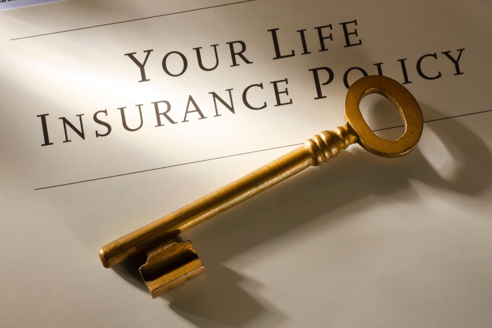 A life insurance policy folder and key