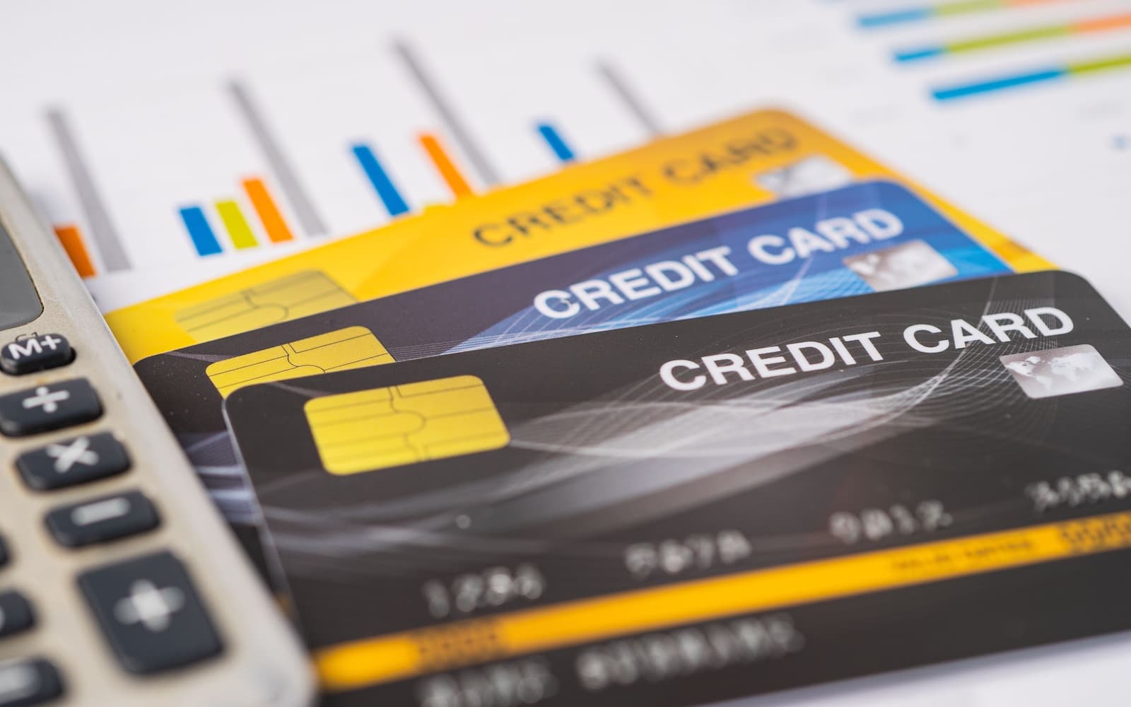Credit cards on chart, next to a calculator