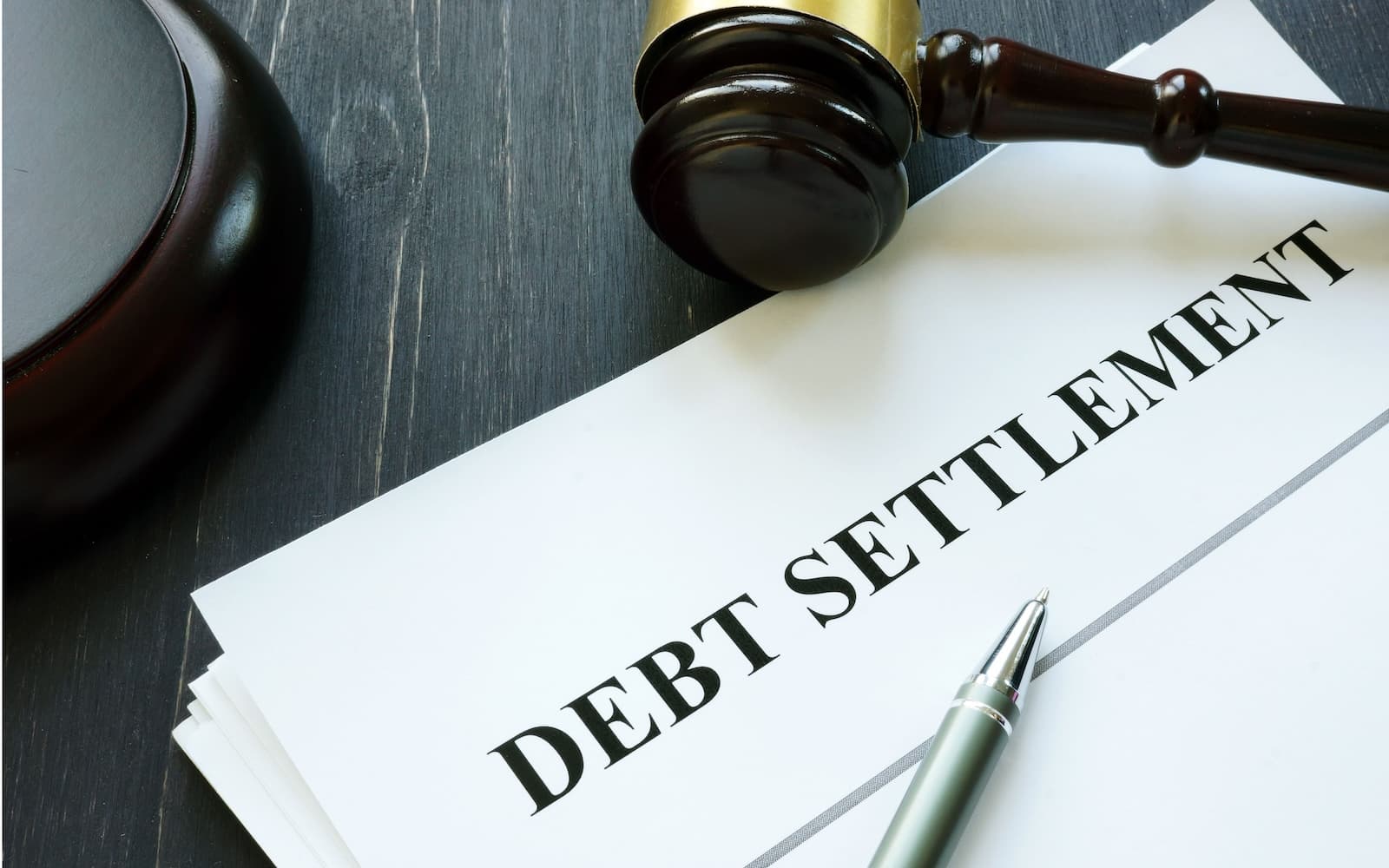 A debt settlement folder near a gavel