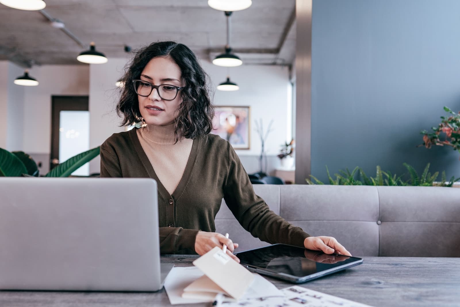 A woman looking at a laptop on desk