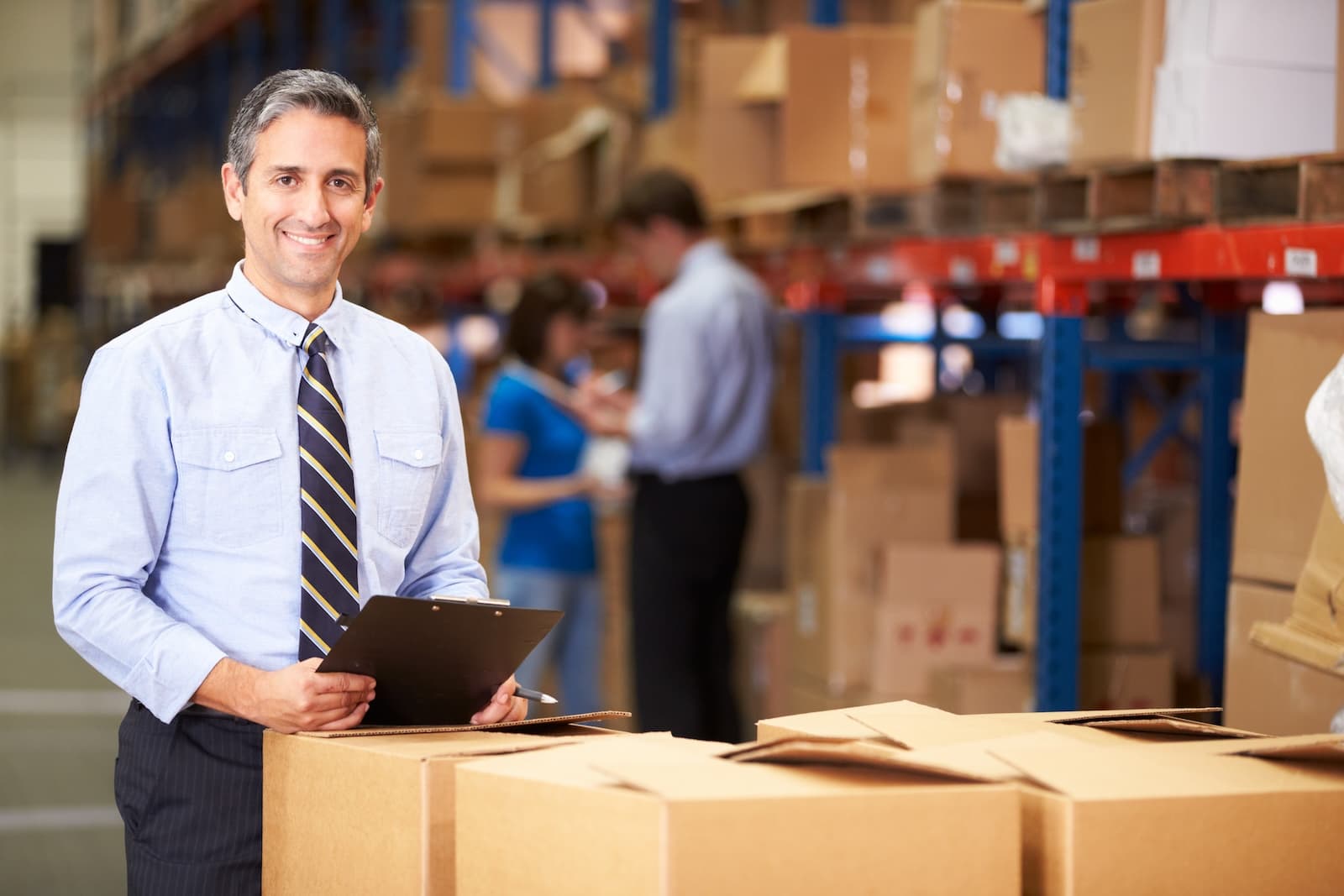Small business owner and employees in warehouse